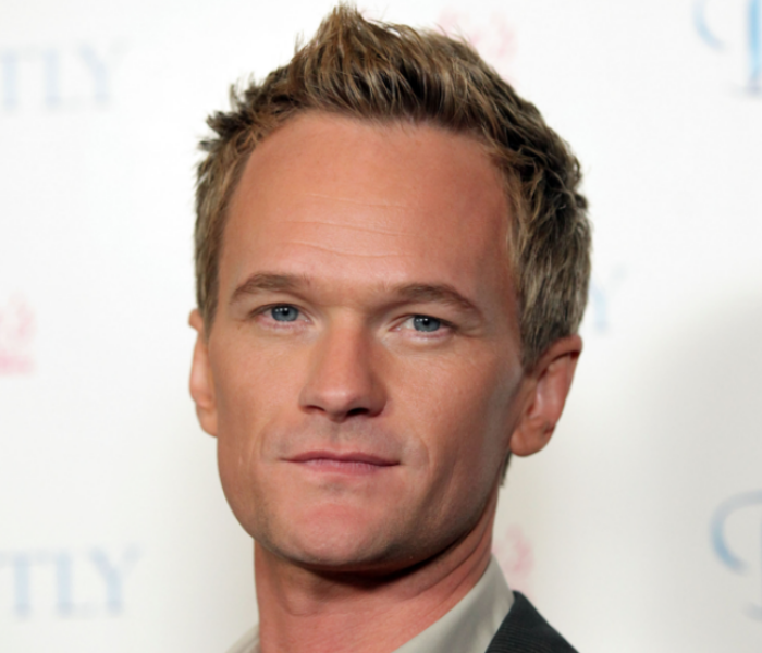A close-up photo of Neil Patrick Harris looking at the camera seriously 