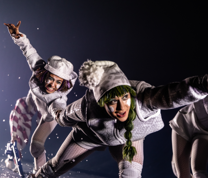 Two dancers dressed as elves with white face paint 